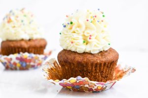 Close-up of cupcakes topped with buttercream frosting and colorful sprinkles, perfect for celebrations.